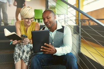 two bookkeepers looking at an ipad