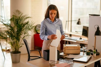 woman decluttering office table