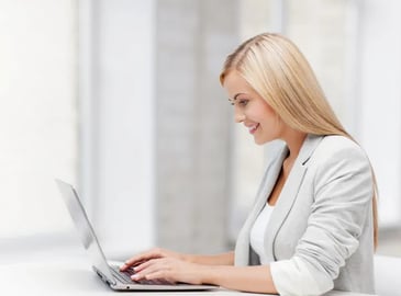 smiling woman using laptop